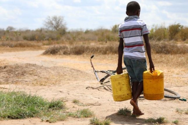 A boy carries buckets of water in Kidemu sub-location in Kilifi County, Kenya, March 23, 2022. The Horn of Africa drought has thrust at least 18.4 million people, including more than 7.1 million acutely malnourished children, into severe food insecurity, UN humanitarians said on Monday. Most drought victims are in Ethiopia, Kenya and Somalia. 