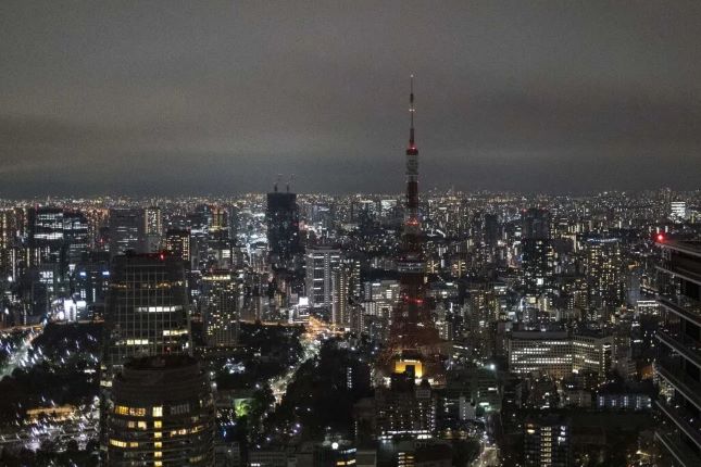 The Tokyo Tower is seen with its lights turned off after 9pm as part of energy-saving measures following a government electricity supply warning for the capital and surrounding areas, in Tokyo on March 22, 2022.